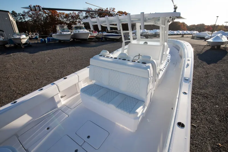 Slide: The Image of 2024 Invincible 39 Open Fisherman boat, spacious deck, white seating, docked with other boats. - 10