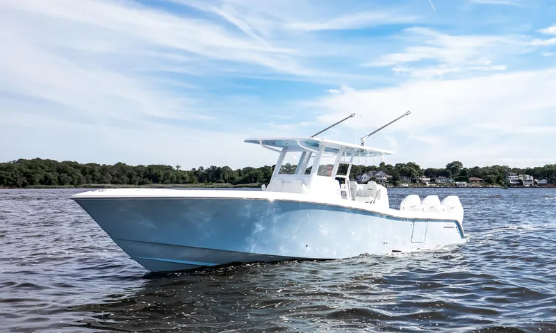 Slide: The Image of 2024 Invincible 39 Open Fisherman boat on calm water under a clear sky. - 2