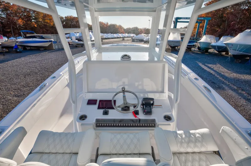 Slide: The Image of 2024 Invincible 39 Open Fisherman boat cockpit with steering wheel and controls. - 7