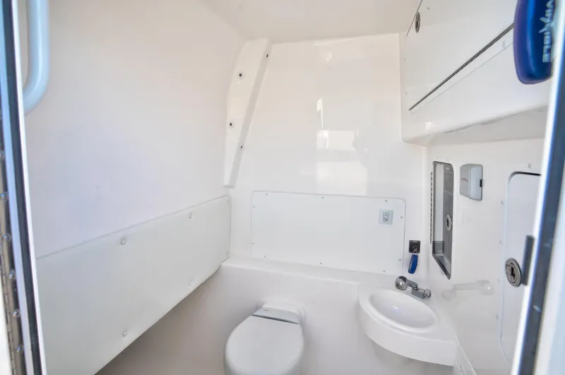 Slide: The Image of 2024 Invincible 39 Open Fisherman boat interior bathroom with toilet and sink. - 9