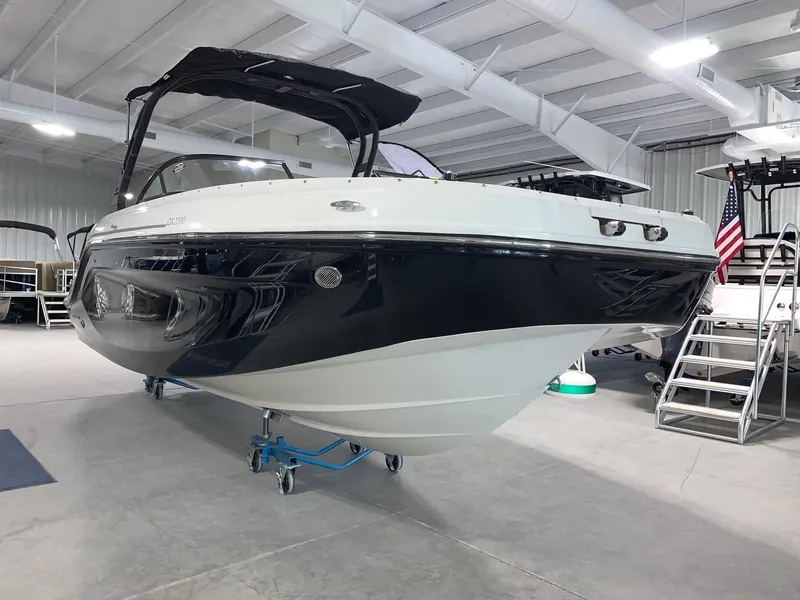 Slide: The Image of 2024 Bayliner DX2200 boat displayed in a showroom. - 2