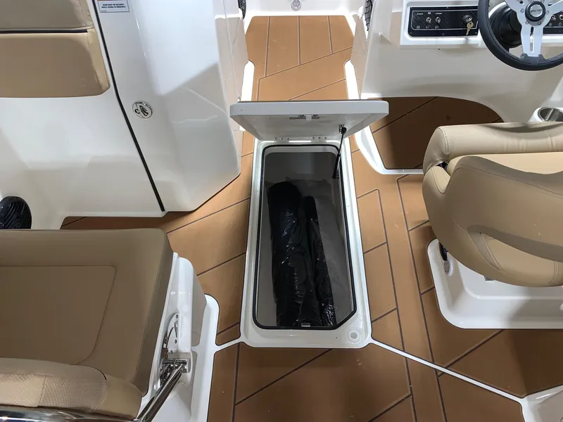 Slide: The Image of 2024 Bayliner DX2200 boat interior with open storage compartment. - 8