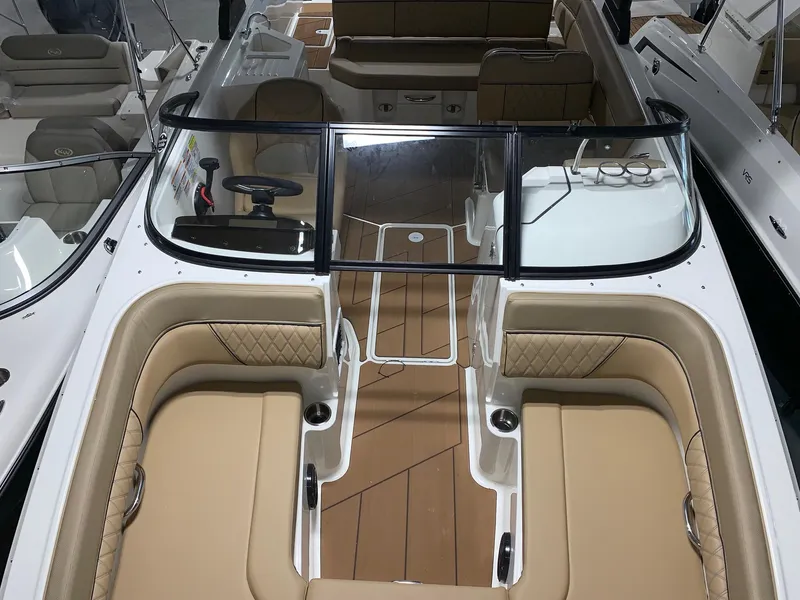 Slide: The Image of 2024 Bayliner DX2200 boat interior with tan seating and modern design. - 11