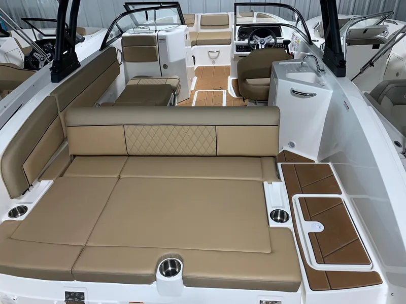 Slide: The Image of 2024 Bayliner DX2200 boat interior with tan seating and modern design. - 13
