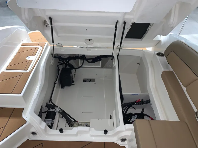 Slide: The Image of 2024 Bayliner DX2200 boat interior storage compartment with open hatch. - 14