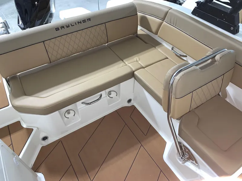 Slide: The Image of 2024 Bayliner DX2200 boat interior with tan seating and diamond stitching. - 4