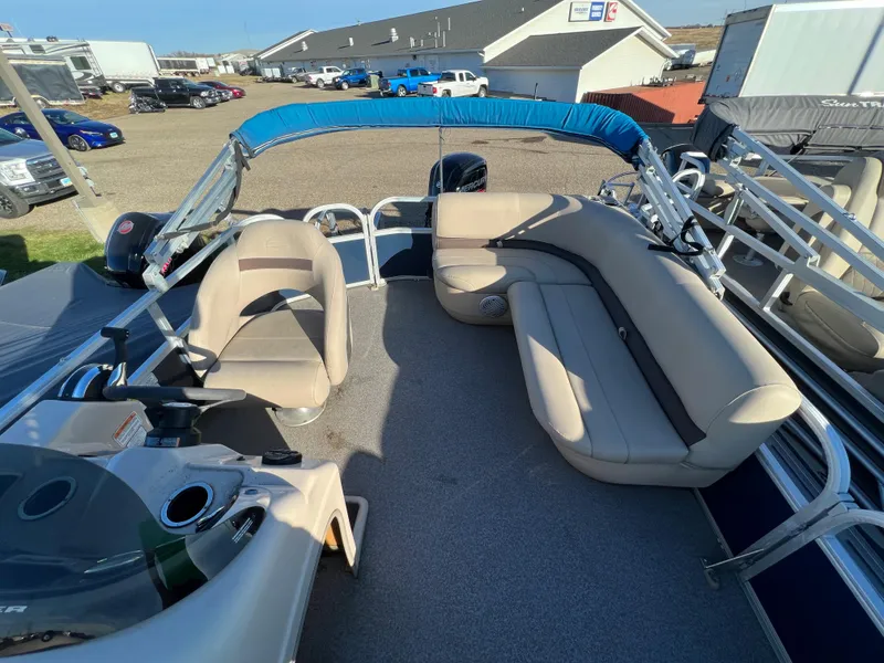 Slide: The Image of 2019 Sun Tracker Party Barge 18 DLX pontoon boat with beige seating and blue canopy. - 4