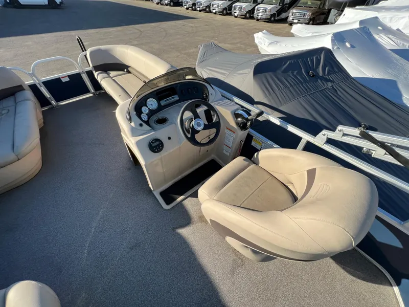 Slide: The Image of 2019 Sun Tracker Party Barge 18 DLX interior with helm and seating. - 5
