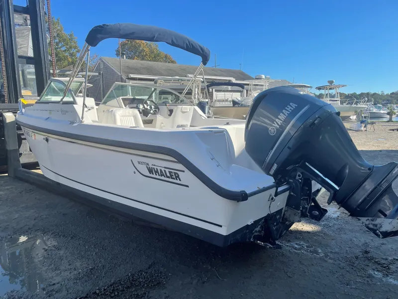 Slide: The Image of 2002 Boston Whaler VENTURA 210 boat with Yamaha outboard motor in a marina. - 11
