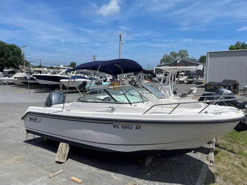 Slide: The Image of 2002 Boston Whaler VENTURA 210 boat on stands in a marina. - 4
