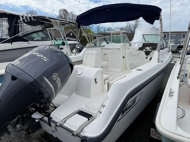 Slide: The Image of 2002 Boston Whaler VENTURA 210 boat with Yamaha 225 engine, docked outdoors. - 5