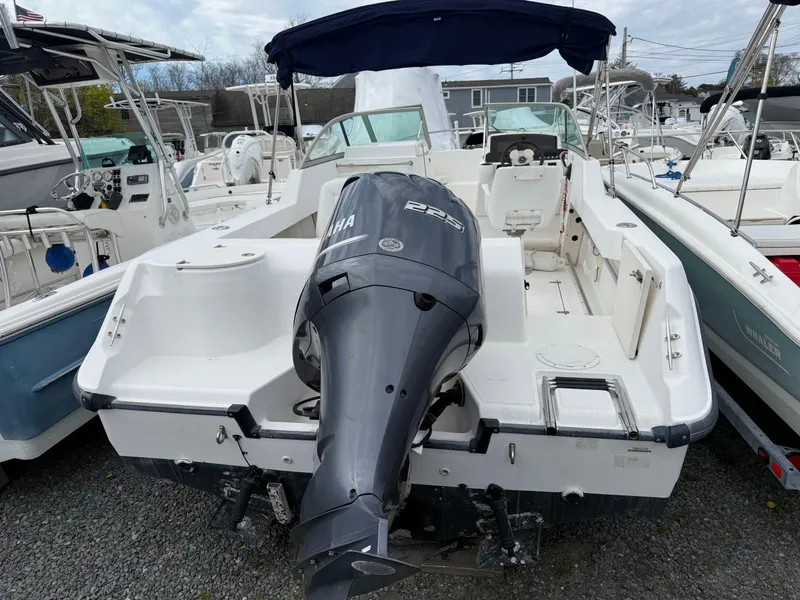 Slide: The Image of 2002 Boston Whaler VENTURA 210 boat with Yamaha outboard motor, docked in a marina. - 6