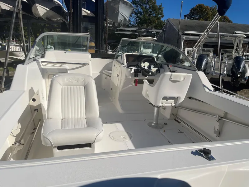 Slide: The Image of 2002 Boston Whaler VENTURA 210 boat interior with white seating and steering console. - 7