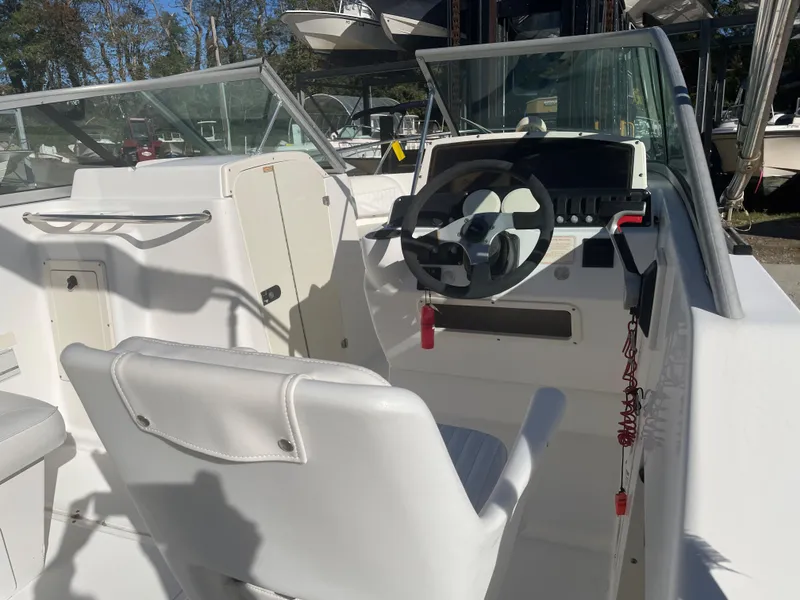 Slide: The Image of 2002 Boston Whaler VENTURA 210 boat interior with steering wheel and seating. - 8