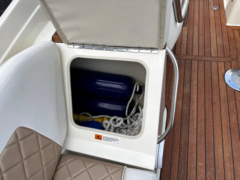 Slide: The Image of Storage compartment on a 2014 Chris-Craft 28 LAUNCH boat with ropes and fenders. - 11