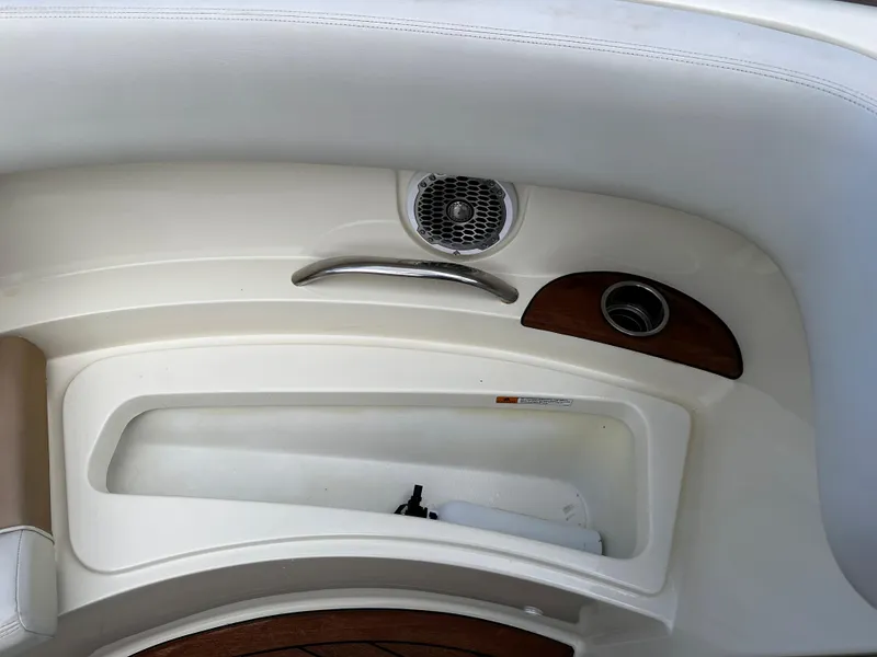Slide: The Image of 2014 Chris-Craft 28 LAUNCH boat interior detail with speaker and storage compartment. - 13