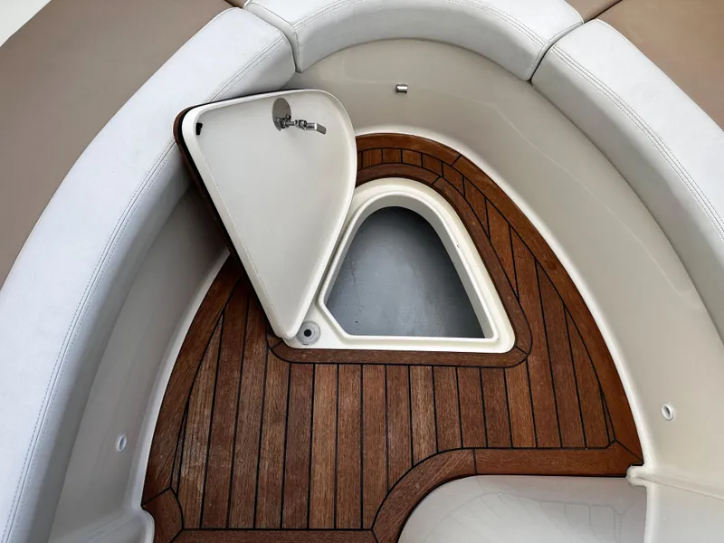 Slide: The Image of 2014 Chris-Craft 28 LAUNCH boat interior with open storage compartment and wooden flooring. - 15