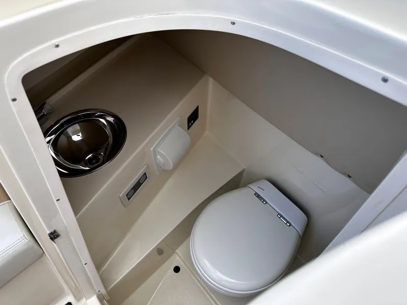 Slide: The Image of 2014 Chris-Craft 28 LAUNCH boat interior bathroom with toilet and sink. - 16