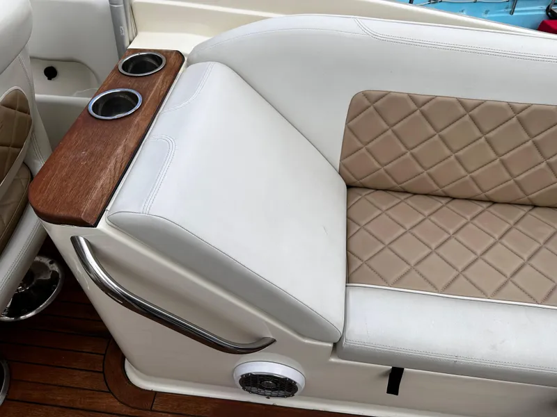Slide: The Image of 2014 Chris-Craft 28 LAUNCH boat interior with tan diamond-stitched seats and cup holders. - 8