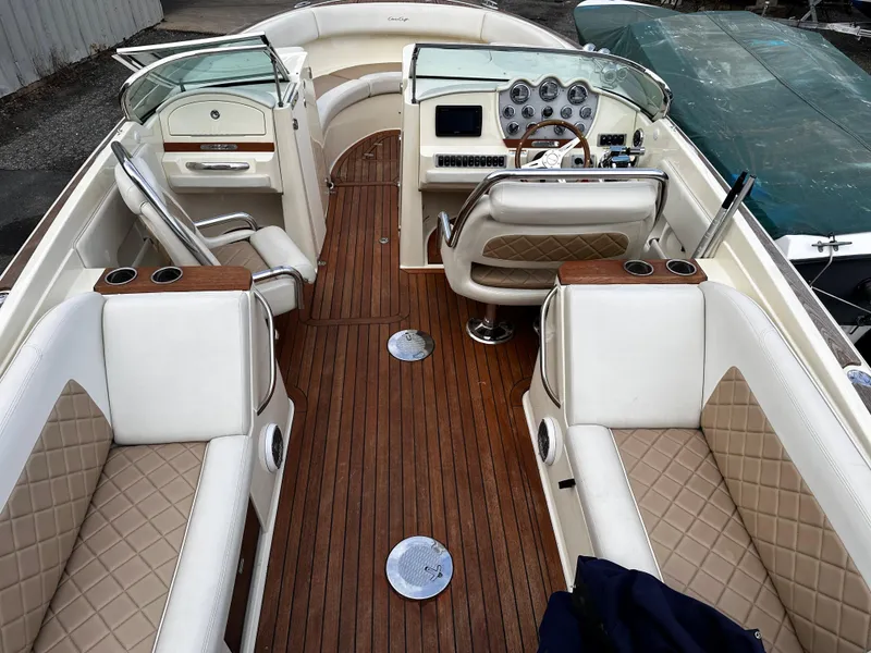 Slide: The Image of 2014 Chris-Craft 28 LAUNCH boat interior with luxurious seating and wooden flooring. - 9