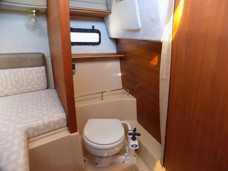 Slide: The Image of 2019 Ranger Tugs R-23 boat interior with compact bathroom and seating area. - 10