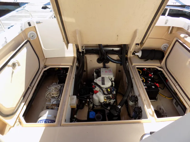 Slide: The Image of Engine compartment of 2019 Ranger Tugs R-23 boat, showing mechanical components and storage areas. - 16