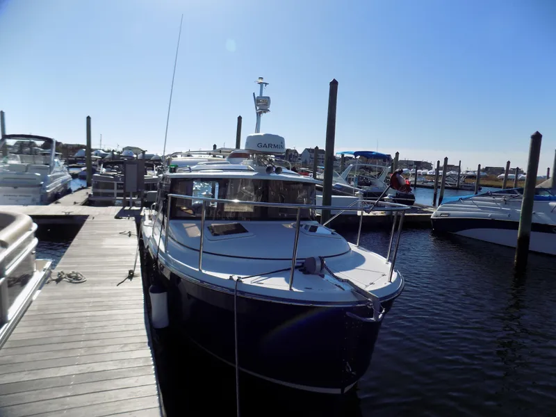 Slide: The Image of 2019 Ranger Tugs R-23 boat docked at marina under clear blue sky. - 5