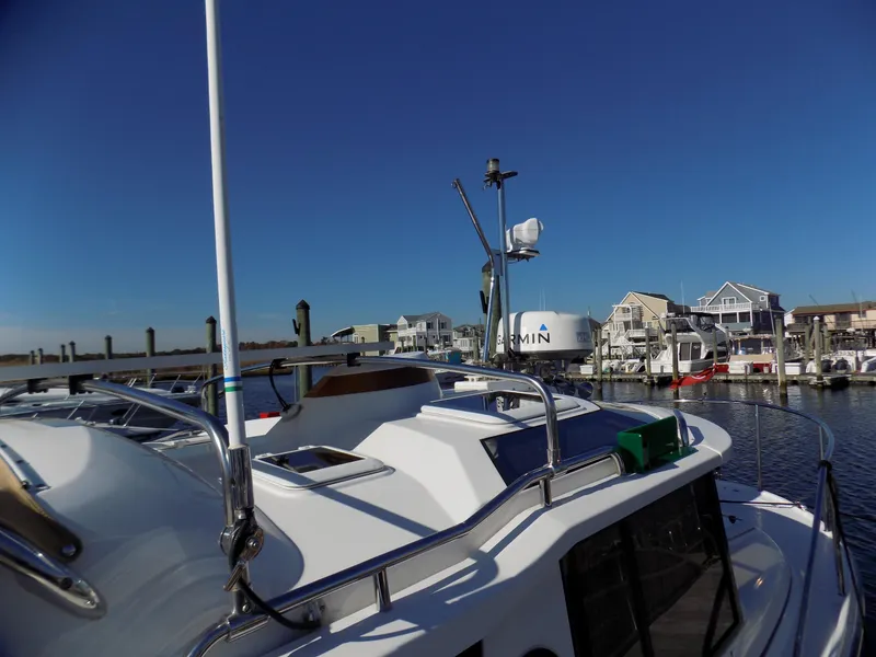 Slide: The Image of 2019 Ranger Tugs R-23 boat docked at a marina with clear blue skies. - 6