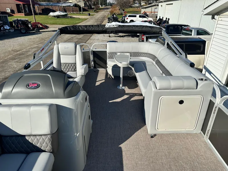 Slide: The Image of 2023 Ranger RP220C pontoon boat with spacious seating and modern interior design. - 4