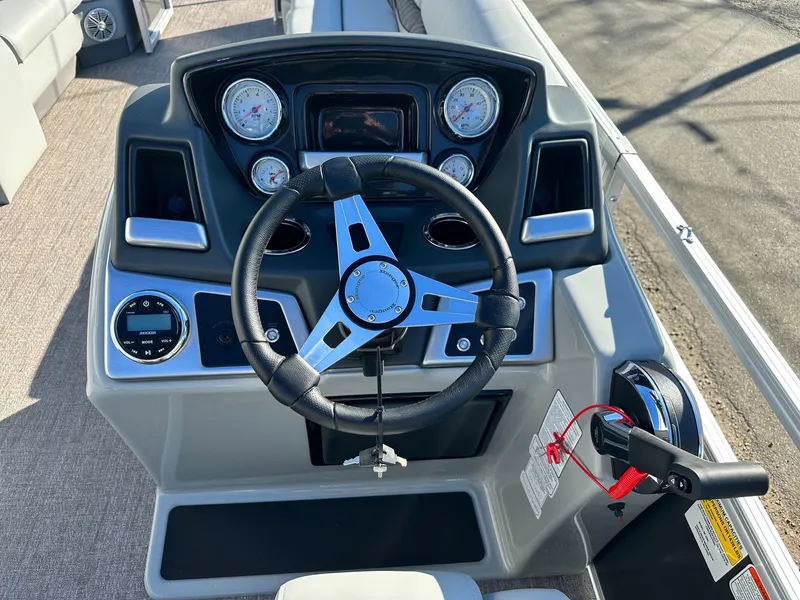 Slide: The Image of 2023 Ranger RP220C boat dashboard with steering wheel and control panel. - 5