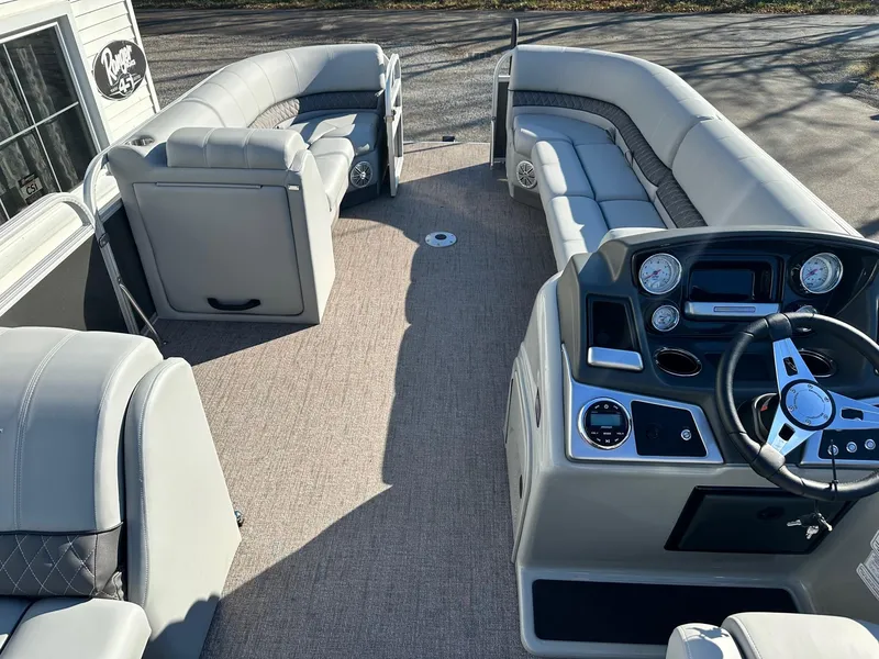 Slide: The Image of 2023 Ranger RP220C pontoon boat interior with plush seating and modern dashboard. - 6