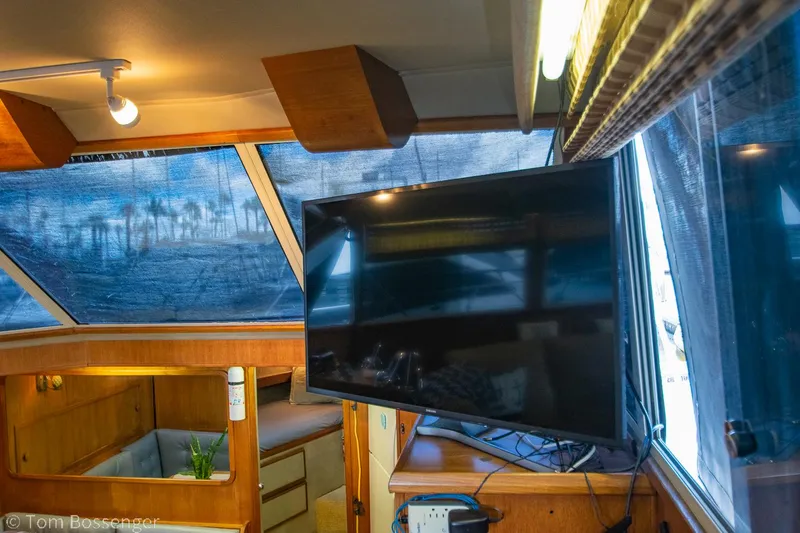Slide: The Image of Interior of 1986 Chris-Craft Corinthian yacht with TV and wooden furnishings. - 11