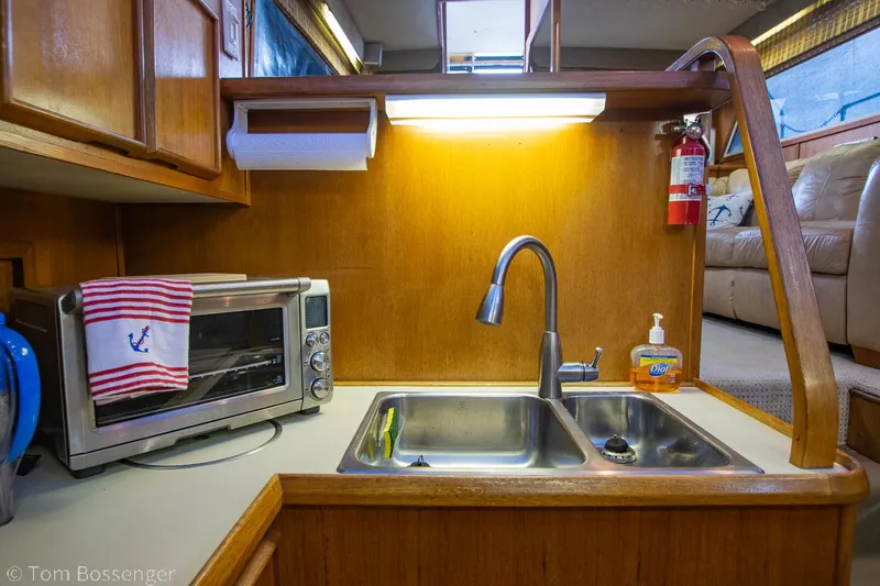 Slide: The Image of 1986 Chris-Craft Corinthian kitchen with sink, toaster oven, and fire extinguisher. - 18