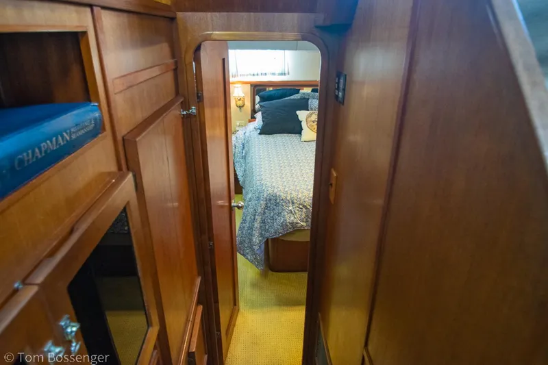 Slide: The Image of 1986 Chris-Craft Corinthian cabin interior with wooden paneling and cozy bedroom. - 20