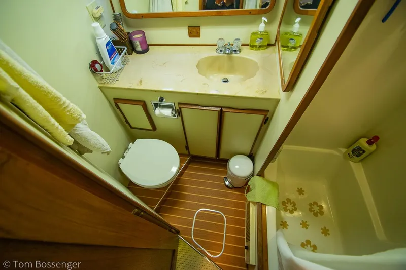 Slide: The Image of Bathroom interior of 1986 Chris-Craft Corinthian boat with sink, toilet, and shower. - 27