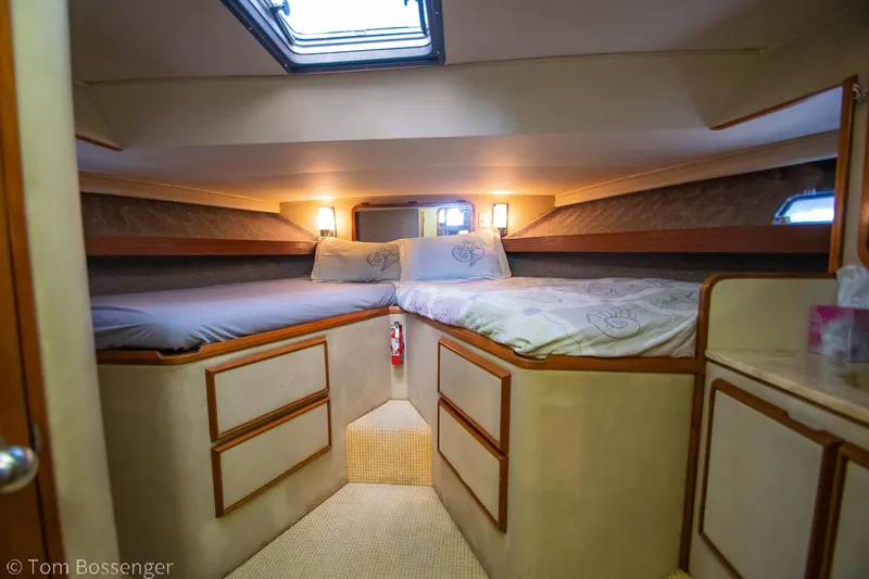 Slide: The Image of 1986 Chris-Craft Corinthian cabin interior with cozy twin beds and soft lighting. - 29