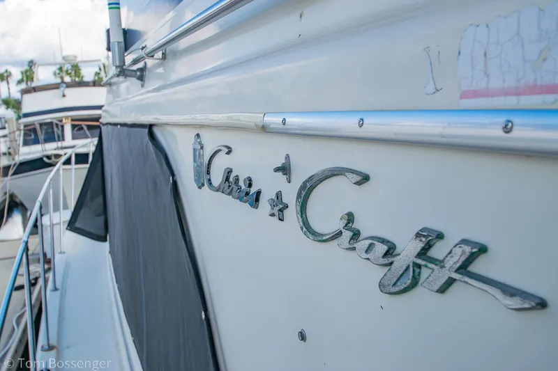 Slide: The Image of 1986 Chris-Craft Corinthian boat with logo, docked in a marina. - 3