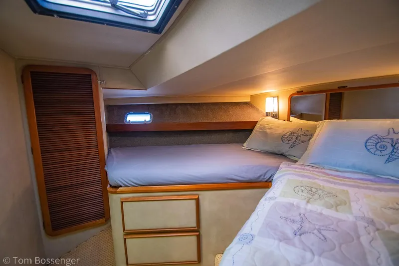 Slide: The Image of Cozy cabin interior of 1986 Chris-Craft Corinthian with bed and soft lighting. - 30