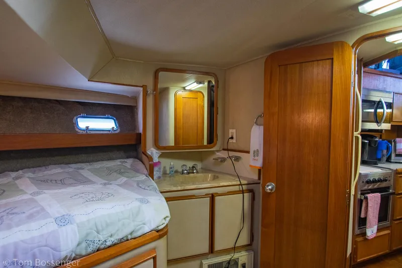 Slide: The Image of Interior of 1986 Chris-Craft Corinthian boat with cozy bed and kitchenette. - 31
