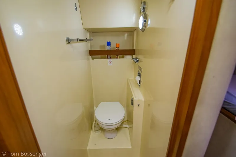 Slide: The Image of 1986 Chris-Craft Corinthian boat bathroom with toilet and porthole window. - 32