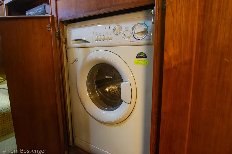Slide: The Image of Washing machine inside 1986 Chris-Craft Corinthian boat's wooden cabinet. - 34