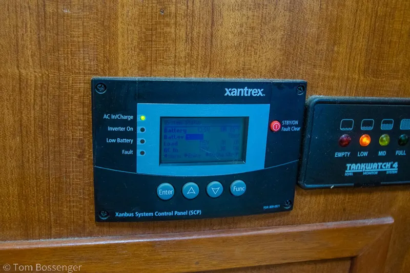 Slide: The Image of Control panel on 1986 Chris-Craft Corinthian boat, featuring Xantrex and TankWatch systems. - 38