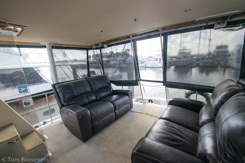 Slide: The Image of Interior of 1986 Chris-Craft Corinthian yacht with leather seating and marina view. - 39