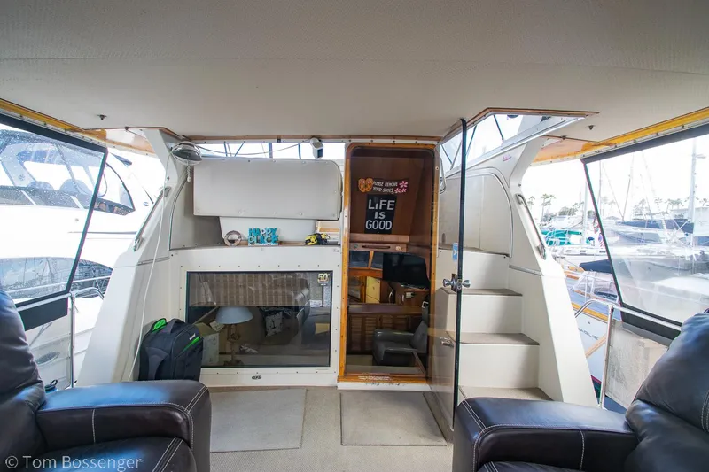 Slide: The Image of 1986 Chris-Craft Corinthian yacht interior with seating, stairs, and decor. - 4