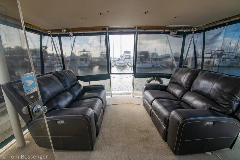 Slide: The Image of Luxurious 1986 Chris-Craft Corinthian yacht interior with leather sofas and marina view. - 40