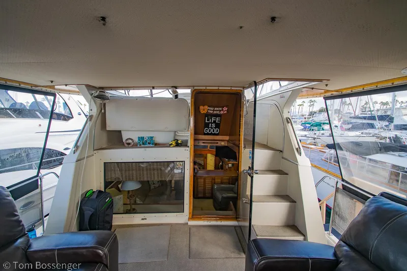 Slide: The Image of 1986 Chris-Craft Corinthian boat interior with seating, stairs, and "Life is Good" sign. - 41