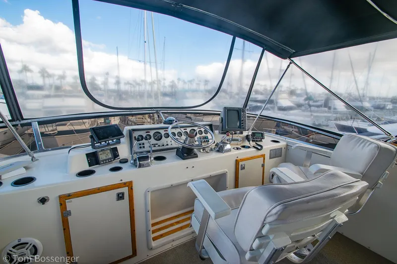 Slide: The Image of 1986 Chris-Craft Corinthian yacht helm with modern navigation equipment and comfortable seating. - 43