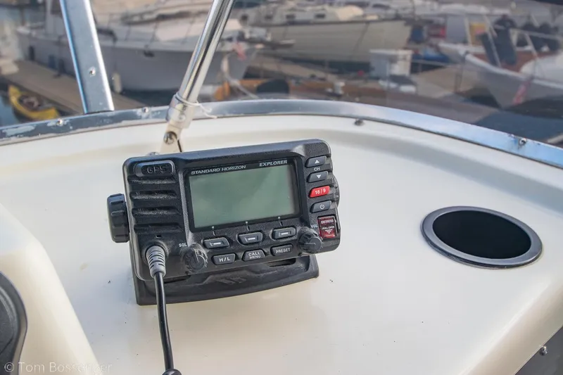 Slide: The Image of 1986 Chris-Craft Corinthian boat dashboard with marine radio and cup holder. - 48