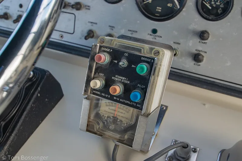 Slide: The Image of Control panel of a 1986 Chris-Craft Corinthian boat with steering and navigation buttons. - 49