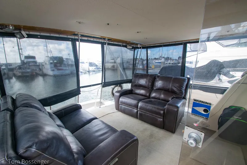 Slide: The Image of 1986 Chris-Craft Corinthian yacht interior with leather seating and marina view. - 5